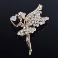 Primer plano de un elegante broche de hada dorado con brillantes diamantes de imitación - Bailarina de Ballet / Blanco