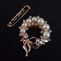 Macro detail of elegant pearl brooch with sparkling crystals and rose gold alloy bow - Pearl Scarf Buckle Style