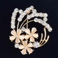 Detailed macro view of gold flower brooch with opal petals and sparkling rhinestones - White
