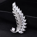 Elegant silver leaf brooch with sparkling zircon inlay over a dark textured backdrop - Marquise Leaf