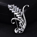 Detailed close-up of a silver wheat-shaped brooch with cubic zirconia on black leather background - Platinum Wheat Ear