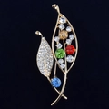 Elegant gold leaf brooch with colorful crystals and sparkling rhinestones on black fabric - Colorful Leaf
