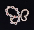 Elegant gold butterfly brooch with pink floral clusters and vibrant crystal accents - White