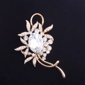 Macro shot of elegant rose gold flower brooch with crystal inlay on black background - White Crystal