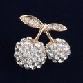 Detailed view of luxury cherry brooch with sparkling rhinestones and gold alloy plating - White
