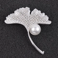 Macro view of silver ginkgo leaf brooch with sparkling crystals and a large pearl - Silver Style (c-69)