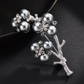 Macro detail of branch-shaped silver brooch with gray pearls and sparkling rhinestones - Matte Silver Branch Gray Pearl