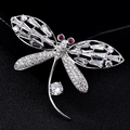 Luxury dragonfly crystal brooch with silver wings and ruby-red accents on black background - Zircon Dragonfly