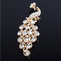 Detailed macro view of golden peacock brooch with sparkling white rhinestones and black eye - Small Peacock