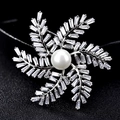 Luxury silver windmill brooch with white pearl center and baguette-cut cubic zirconia - Windmill Leaf