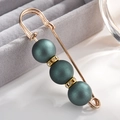Macro detail of alloy brooch with matte dark green pearls and glittering rhinestones - Navy Blue