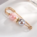 Detail view of elegant gold-plated alloy brooch with iridescent pearls and fine rhinestones - Pink