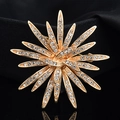 Elegant gold sunburst brooch with sparkling rhinestones on a black textured background - Gold Sunflower