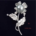 Detailed view of silver flower brooch with grey faux pearl and crystal accents, 6.0x3.5cm - Flower