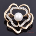 Macro shot of 3.5cm gold-toned camellia brooch with central pearl and rhinestone petals - Single Floral Heart