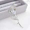 Macro detail of calla lily brooch with micro-pave cubic zirconia on velvet jewelry box - White Gold