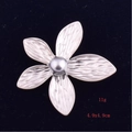 Macro detail of silver flower brooch with shell pearl and radial petal textures - Five-Leaf