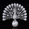 Macro shot of silver peacock brooch with pavé zircon stones and a large white pearl - Silver White Zirconia