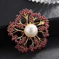 Elegant gold camellia flower brooch with central pearl and purple zircon stones - Red
