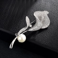 Elegant lily brooch with sparkling cubic zirconia and a white pearl on black leather - Silver