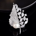 Macro detail of leaf brooch featuring shimmering zircons and a large white round pearl - Large Leaf