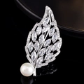 Macro detail of a silver leaf brooch with marquise zircons and a large white pearl inlay - Small Leaf