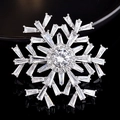 Macro shot of silver snowflake brooch with sparkling cubic zirconia and multi-layer design - Snowflake