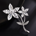 Elegant silver flower brooch with zircon stones on a luxury dark textured background - White Gold