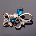 Elegant gold butterfly brooch featuring dark blue teardrop gems and white rhinestones - Butterfly Blue Crystal