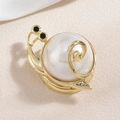Creative snail brooch with white pearl shell and gold-plated metal on silk background - Gold