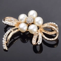 Elegant gold flower and ribbon brooch featuring faux pearls and crystal rhinestones - Pearl Butterfly