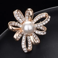 Elegant gold flower brooch with a large white pearl and sparkling crystals on black - Pearl Ring