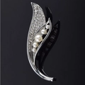 Elegant silver leaf brooch with sparkling crystals and white pearls on black background - Melody of Two Leaves Silver