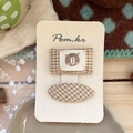 Detail of two-piece checkered fabric hair clips with cute bear embroidery on display card - 2-Piece Set (NK2790) / Yellow Plaid Bear Hairpin