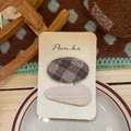 Detail view of plaid and beige knitted hair clips set on a stylish product display card - Oval And Drop