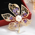 Elegant gold flower brooch with white pearl and purple zircon on a jewelry box - Gold Maple Leaf Purple Zirconia