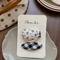 Detail of floral lace heart and black checkered hair clips on a display card - Lace Heart Floral Hair Clips