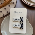 Detail of checkered hair clips with white lace edges and velvet bows on display card - Square Letter Bow Hair Clips
