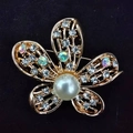 Elegant gold five-petal flower brooch with pearl and crystal inlay on black background - Five-Petal Flower
