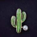 Elegant golden cactus brooch with green enamel, white rhinestones and a pearl accent - Cactus