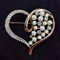 Elegant heart brooch with gold finish, featuring rows of white pearls and sparkling rhinestones - Pearl Heart