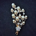 Elegant gold flower brooch with white faux pearls and clear rhinestones on black velvet - String of White Pearls