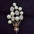 Elegant gold flower bouquet brooch with white pearls and sparkling crystal details - Balloon