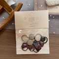 Detailed view of handmade geometric fabric hair ties for children in soft earthy colors - Geometric Faux Leather Style