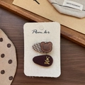 Detail of brown fabric hair clips with embroidered bear and gold metal bunny accents - Plaid Bear Style