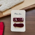 Detail view of handmade wine red fabric hair clips with ribbon bow and white embroidery - Square Embroidery Glove Hair Clips