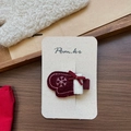 Detailed view of red glove hair clip with snowflake embroidery and white fur trim on card - Mitten Snowflake Hair Clip