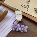 Pair of purple and white checkered flower elastic hair ties with red floral centers - Purple Houndstooth Flower Hair Tie