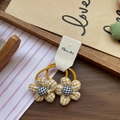 Pair of yellow plaid flower hair ties with elastic rubber bands and button centers - Yellow Houndstooth Flower Hair Tie