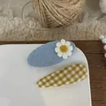 Detail of blue knit hair clip with daisy embroidery and green plaid fabric accessory - Oval Floral And Plaid Teardrop